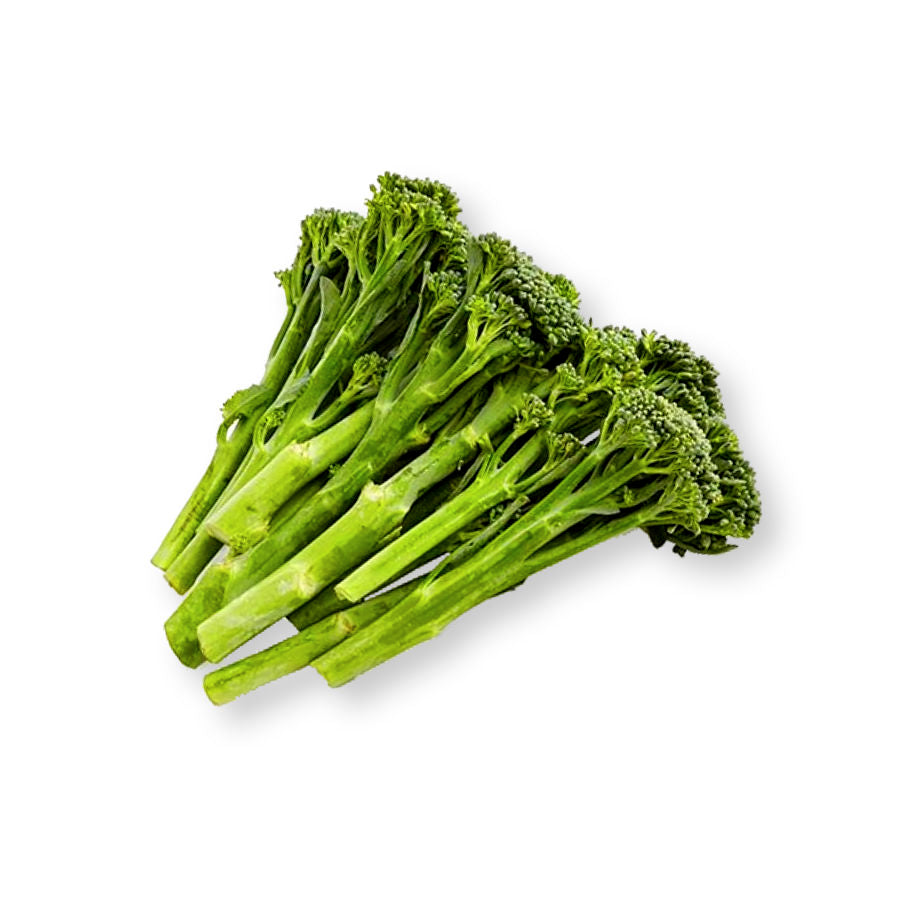 Stem broccoli broccolini plants with slender green stems, leafy foliage, and small green florets growing in a home vegetable garden.