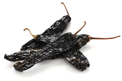 Pasilla pepper seeds for planting with mature dark green chilaca peppers, deep brown dried pasilla chilies, and a healthy pepper plant for home vegetable gardens.