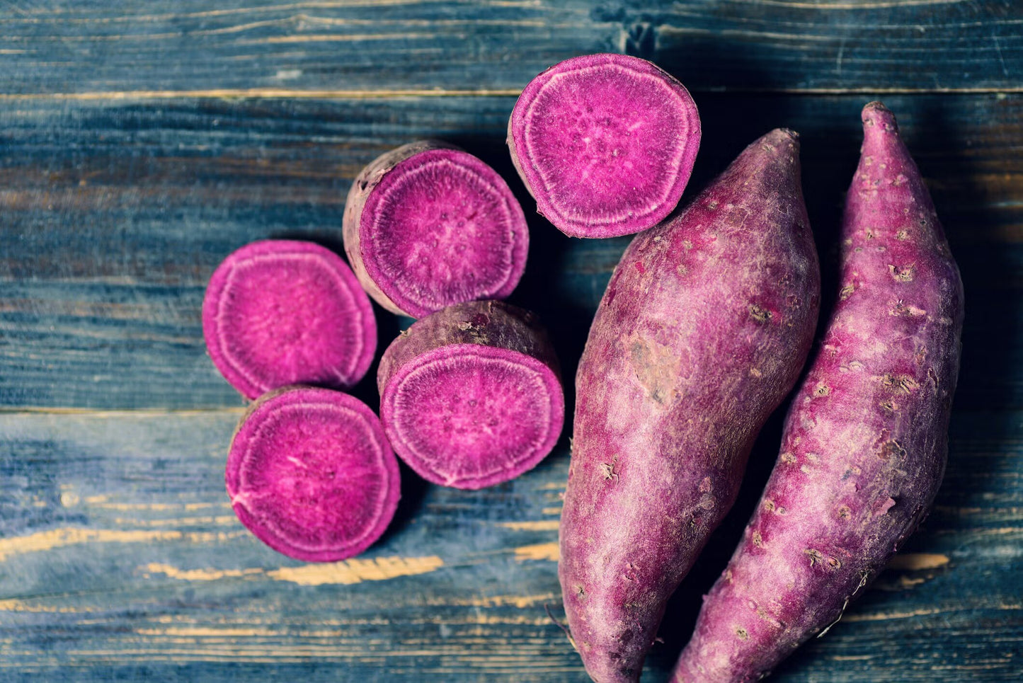 Purple sweet potato vegetable roots growing in a home garden