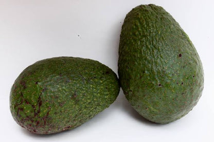 Fresh Sharwil avocado fruit with green skin and creamy flesh, showcasing the fruit variety for home garden growing.