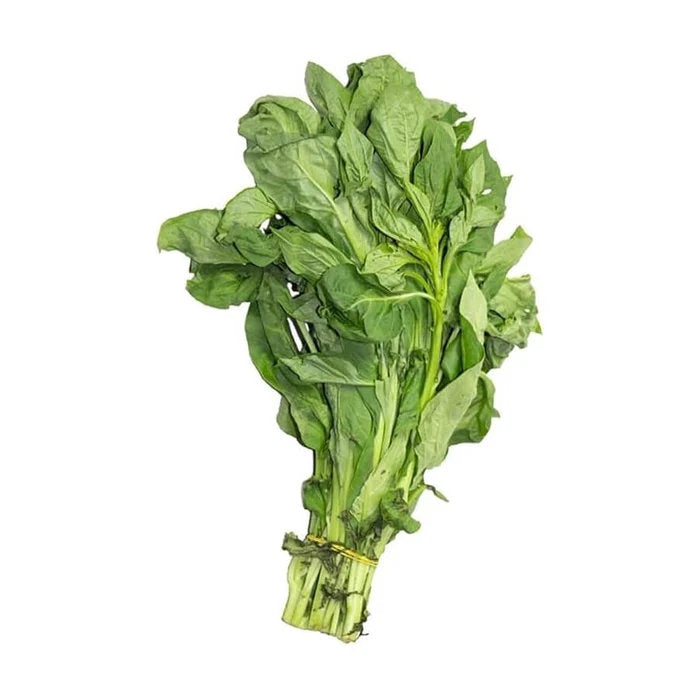 Soko vegetable plants growing with fresh green leaves in a home vegetable garden, illustrating leafy growth and cultivation from seed.